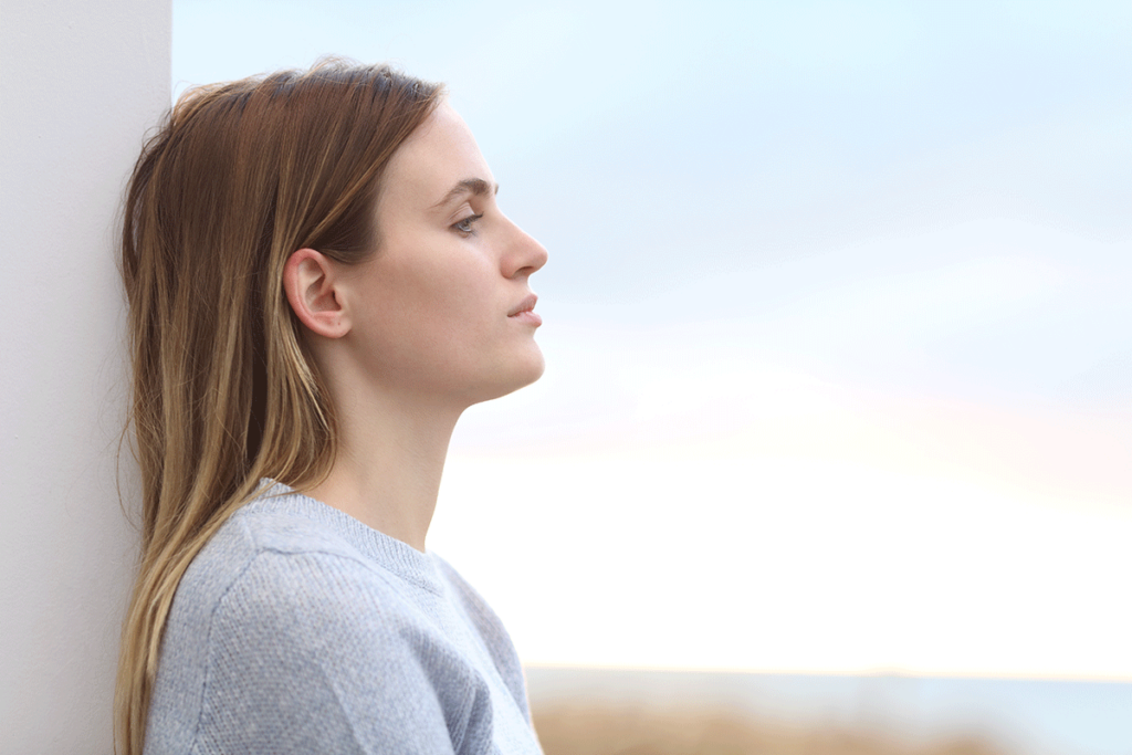 woman leans on a wall and is thinking about what's the difference between suboxone and subutex