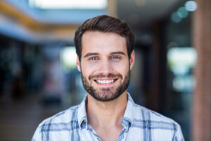 a man with a beard is smiling and wonders how long does suboxone treatment last
